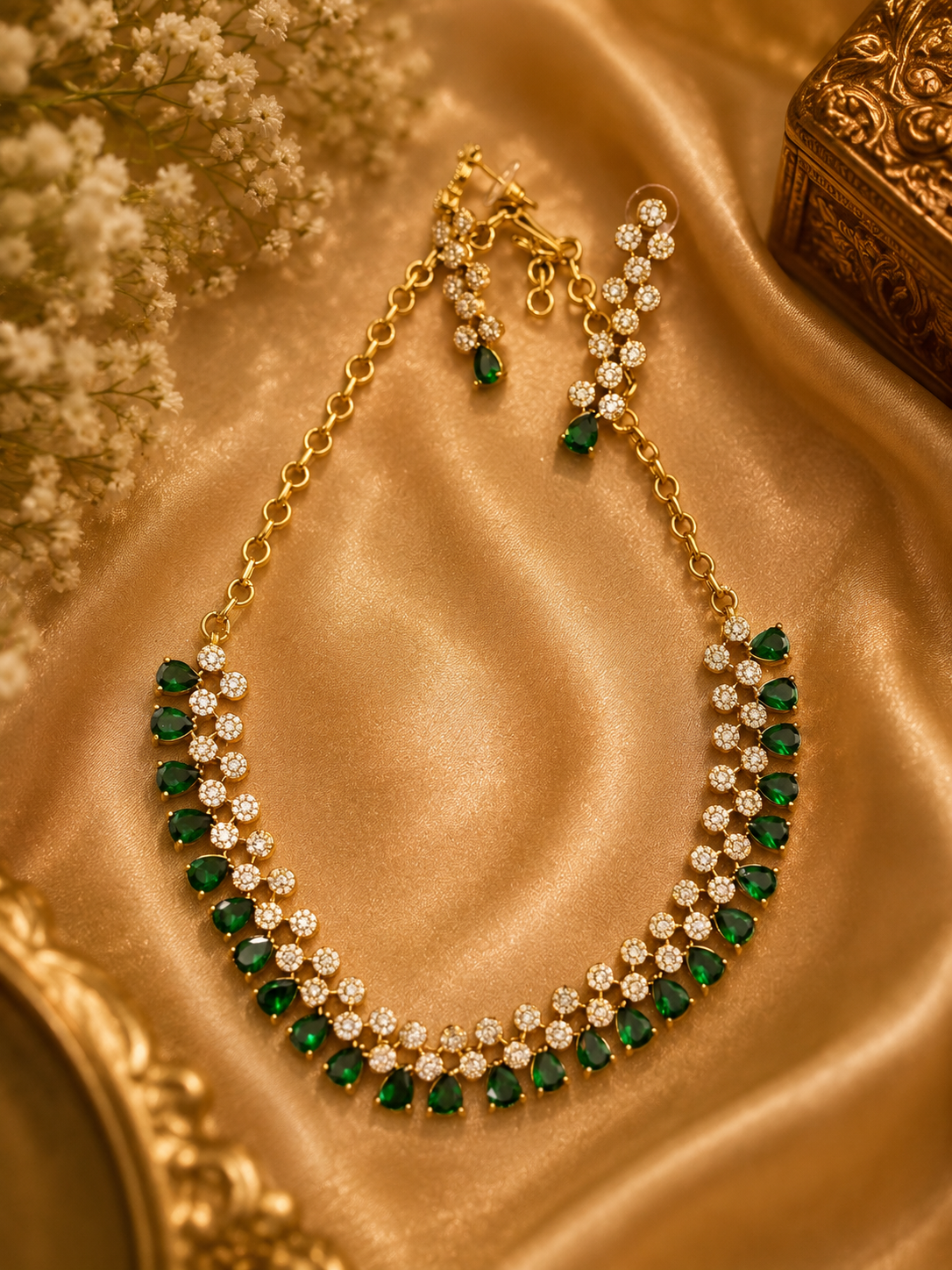 Necklace and earrings set adorned with green emerald stones